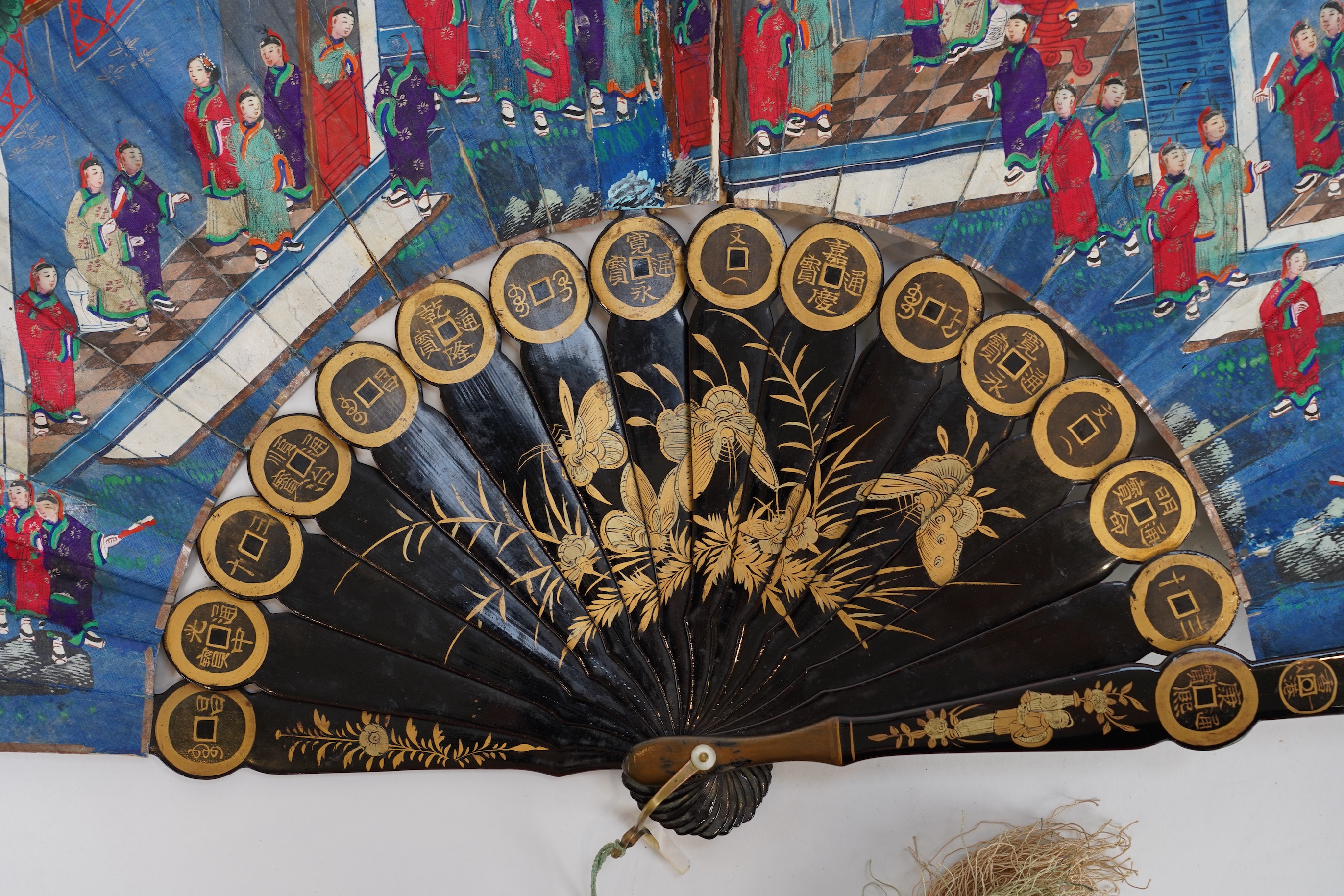 Three Chinese gilt-decorated black lacquer and painted leaf fans, 19th century
